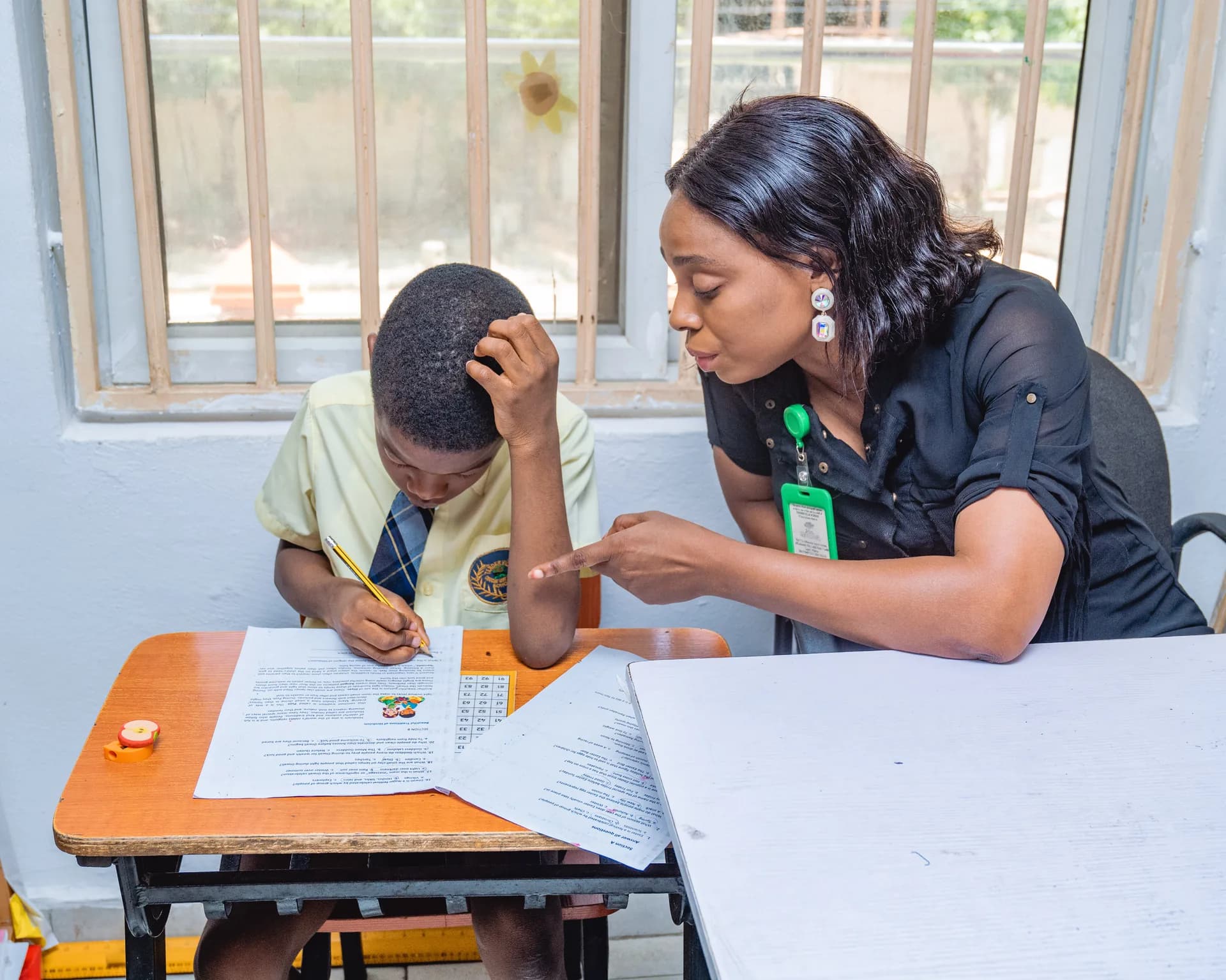 Tenderville teacher giving individual attention to a student