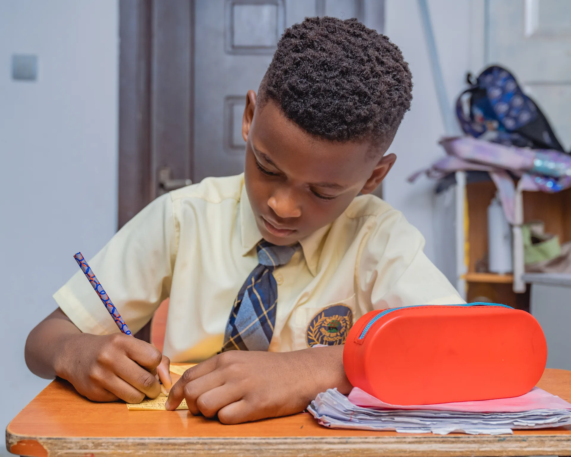 Tenderville student writing in workbook