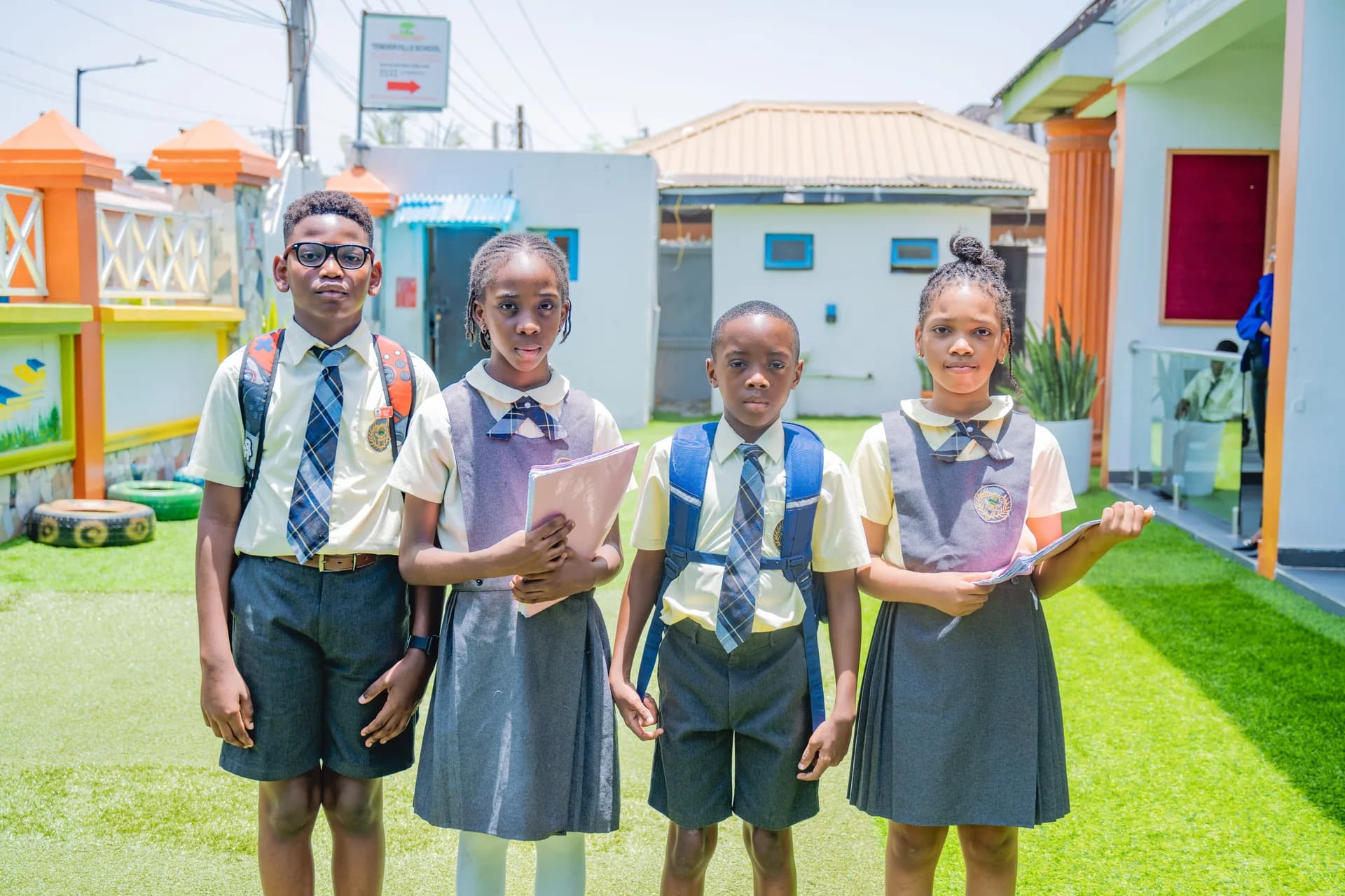 Tenderville student group portrait at the school entrance